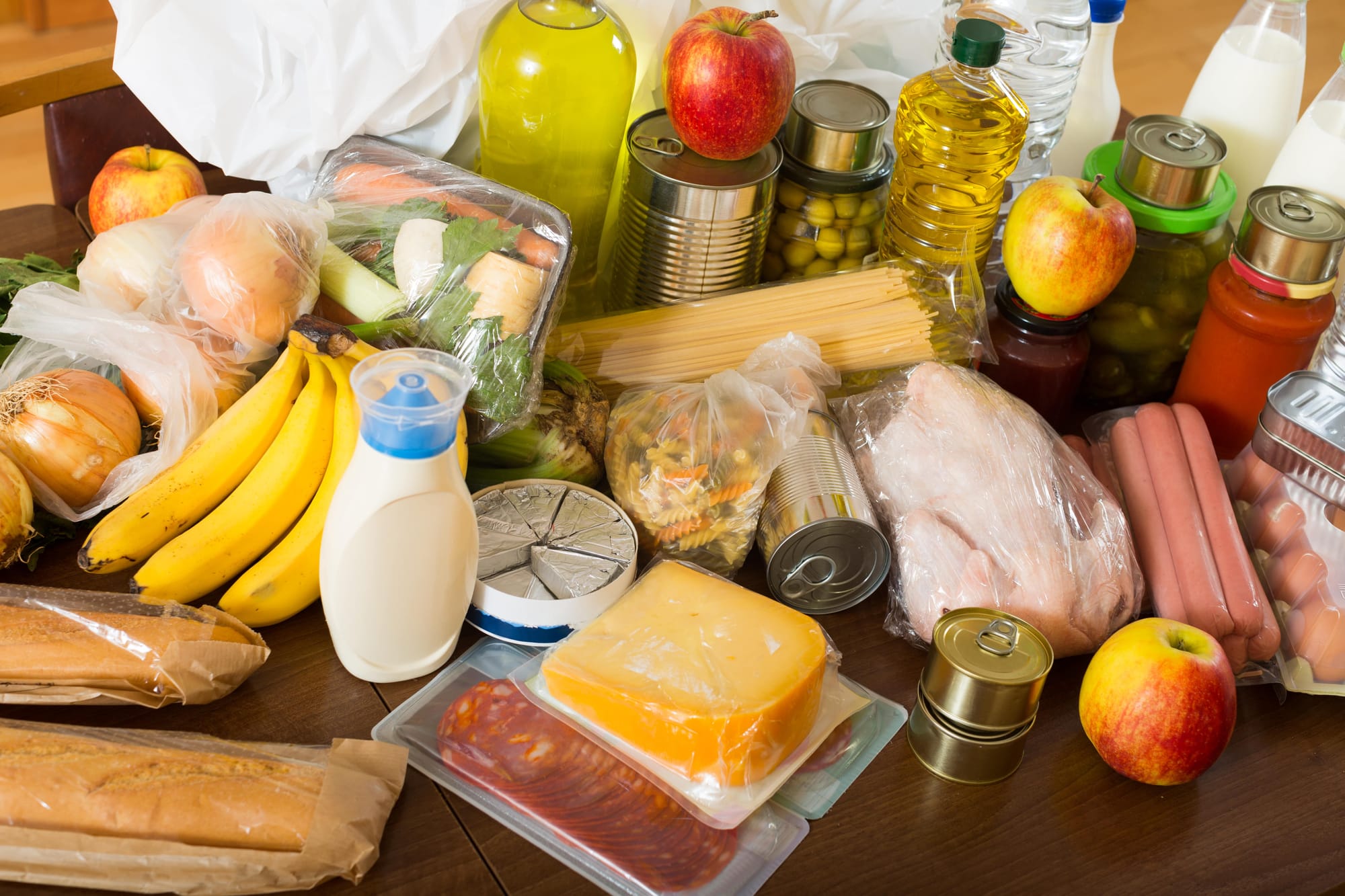 A table set with various dishes, including fruits, vegetables, and other imported packaged food items.