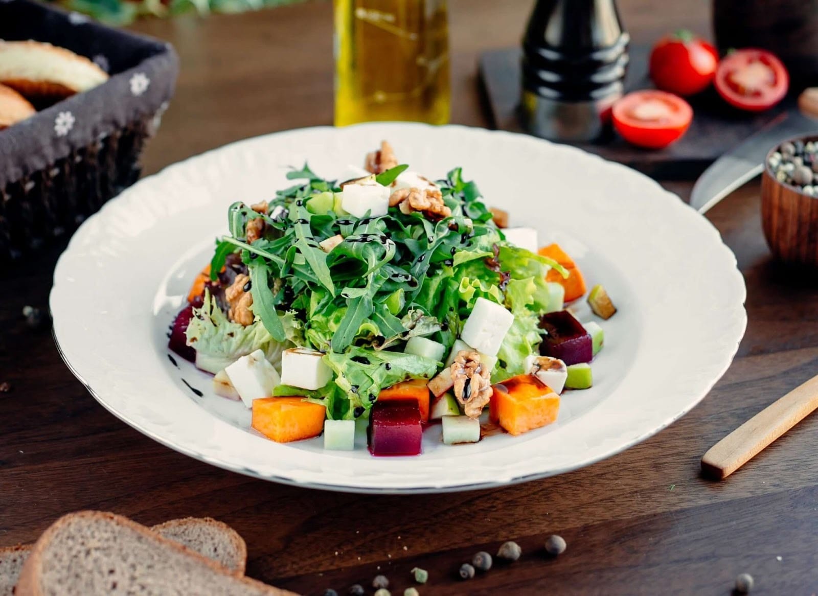 A plate with cheddar cheese, carrot, cucumber, boiled eggs and slice of lean meat.